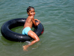 Local girl playing on tube on Don Det Island, Laos